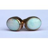 A pair of 9ct gold opal stud earrings.