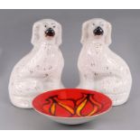 A pair of Staffordshire pottery spaniels, 32cms high; together with a Poole Pottery Delphis bowl,