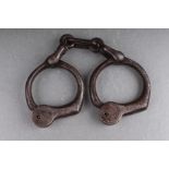 A pair of steel handcuffs (lacks key).