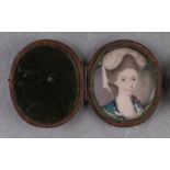 A late 18th century oval portrait miniature on ivory depicting a lady wearing a bonnet, 3.5 by 4cms,