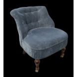 A Victorian style upholstered button-backed nursing chair on turned front legs.Condition