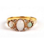 An 18ct gold opal and diamond ring, approx UK size 'M'.