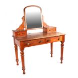 A Victorian stripped pine dressing table with two frieze drawers, on turned legs, 107cms wide.
