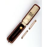 A Victorian 15ct gold pearl set stick pin, 1.3g, boxed; together with two 9ct gold tie pins, 4g.