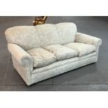 A country house style three-seater sofa with scroll arms and feather filled cushions, 190cms wide.