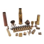 An assortment of trench art, brass shell cases, lighters and inert munitions.