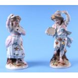 A pair of continental porcelain figural spill vases, 21cms high (2).