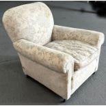 A country house style armchair with feather filled cushions.