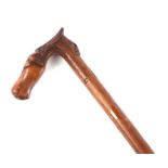 An olive wood walking stick, the handle carved in the form of a horse and a bearded gentleman's
