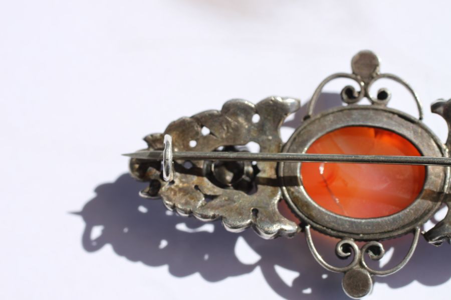 An Austro-Hungarian white metal brooch set with a central oval hardstone cabochon and six pale green - Image 11 of 12
