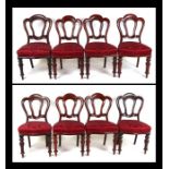 A matched set of eight Victorian mahogany dining chairs with serpentine front overstuffed seats,