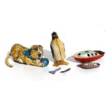 Three tinplate clockwork toys to include a Mar Toys cat playing with a ball, 12cms long; a penguin