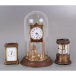 An Anniversary type clock under a glass dome, 30cms high; together with a Waterbury Clock Company