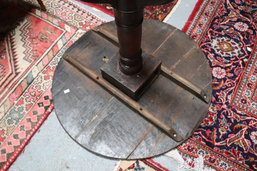 A 19th century oak tilt-top table on turned column and tripod base, 69cms diameter. - Image 3 of 5