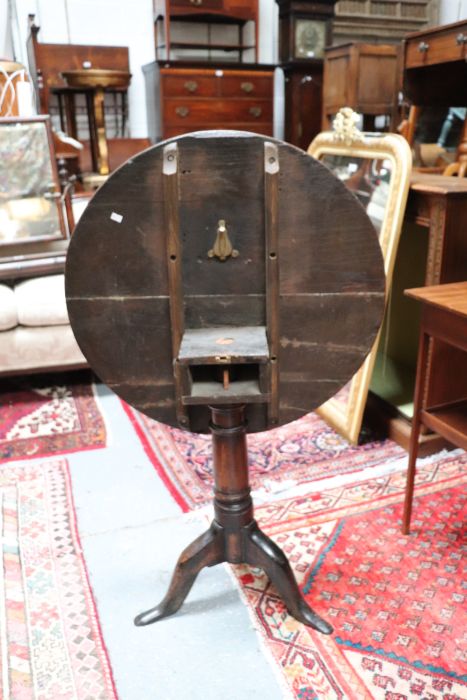 A 19th century oak tilt-top table on turned column and tripod base, 69cms diameter. - Image 5 of 5