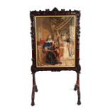 A 19th century carved mahogany fire screen with needlework panel depicting Charles I, Courtiers