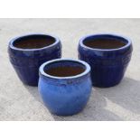 A pair of blue glazed garden planters, 34cms diameter; together with a similar smaller, 28cms