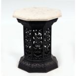 An octagonal marble topped occasional table on pierced cast iron base, 34cms wide.