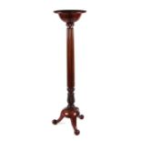 A Victorian mahogany torchere with bowl top on a reeded column terminating in acanthus leaf and ball