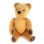 A vintage plush jointed teddy bear, 43cms high.