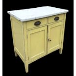 An early 20th century painted pine kitchen cabinet with rectangular enamel top above two drawers and