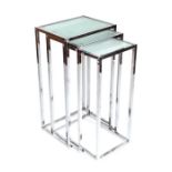 A nest of three modern design chrome and frosted glass tables, the largest 40cms wide.