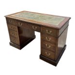A late 19th century walnut pedestal desk, the rectangular top with inset green leather above an