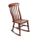 A 19th century slat-back child's rocking chair.