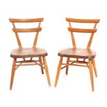 A pair of Ercol mid-century Yellow Dot children's stacking chairs (2).