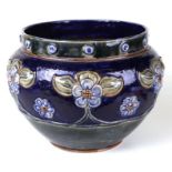 A Royal Doulton stoneware jardiniere decorated with stylised flowers, on a blue ground, 33cms