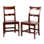A pair of 19th century oak hall chairs.