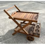 A teak two-tier garden drinks trolley, 84cms long.