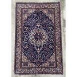 A Persian rug with geometric floral design on a blue ground within a multi border, 130 by 210cms.