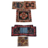 A Tibetan saddle blanket; together with three Tibetan hand knotted meditation rugs, the largest 88