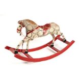 An early 20th century straw filled rocking horse, possibly German. 105cm long (a/f)