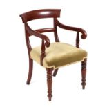 A William IV mahogany desk chair with upholstered stuffed-over seat, on turned front supports.