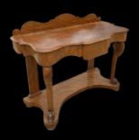 An early 20th century walnut Duchess dressing table with shaped rectangular top and central