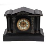 A Victorian ebonised steel mantle clock of architectural design, the white enamel dial with Roman