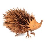 A weathered painted metal garden ornament in the form of a hedgehog, 35cms long.