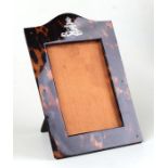 A Royal Artillery white metal mounted tortoiseshell strut photograph frame, overall 14 by 20cms.