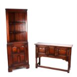 An 18th century style oak sideboard with two panelled doors, on turned legs joined by stretchers,