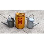 Two galvanised watering cans; together with a Shell two-stroke oil can (3).