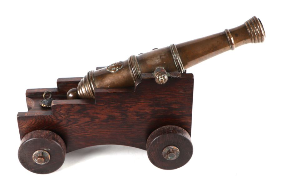 A 19th century bronze signal cannon, 44cms long, on a later wooden carriage.