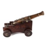 A 19th century bronze signal cannon, 44cms long, on a later wooden carriage.