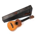 An early 20th century Juan Gomez Barcelona ukulele, bears paper label, 50cms long, cased.