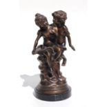 A bronze / patinated brass figural group depicting two young children, 28cms high.