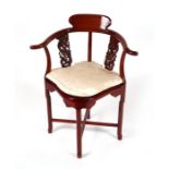 A Chinese hardwood corner chair with silk upholstered cushion.