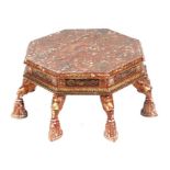 A Kashmiri low prayer table, the octagonal top on eight hoof support legs, 67cms wide.
