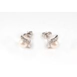 A pair of 9ct white gold pearl and diamond stud earrings, 2.4g.