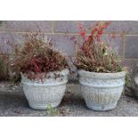 A pair of reconstituted stone garden pots, 28cms high (2).